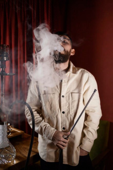 man-relaxing-by-vaping-from-hookah-bar